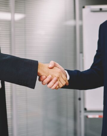 business-colleagues-shaking-hands-in-office-2025-03-26-21-57-22-utc-scaled