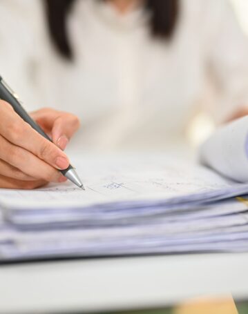 close-up-view-of-female-accountant-holding-pen-wri-2024-12-04-23-47-37-utc-scaled