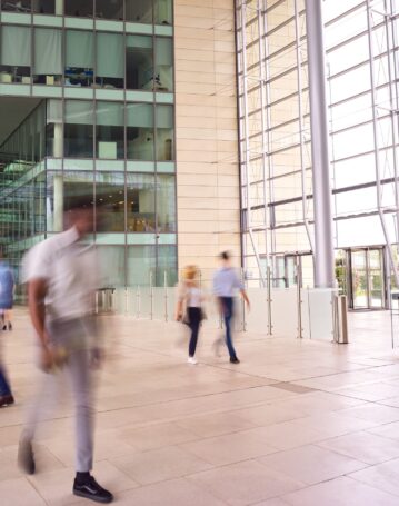 motion-blur-shot-of-businesspeople-in-lobby-of-bus-2024-10-19-07-32-30-utc-scaled