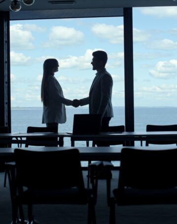 partners-silhouettes-shaking-hands-at-marine-view-2024-11-05-04-28-34-utc-scaled