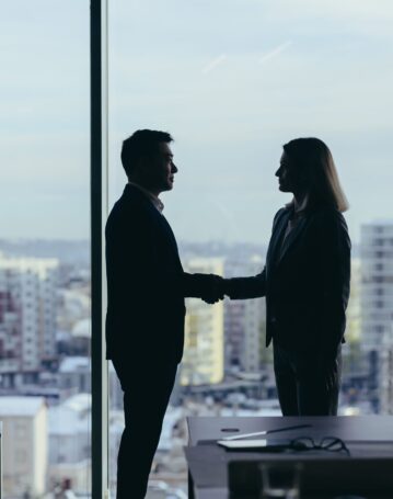silhouettes-of-two-employees-team-of-businessmen-2025-03-25-14-37-05-utc-scaled